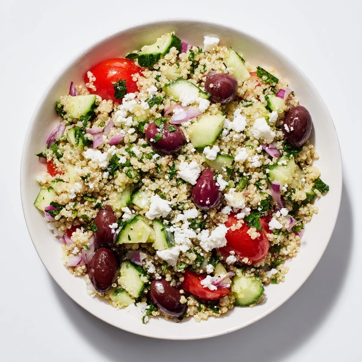 Fluffy quinoa mingles with tomatoes and feta in this vibrant Mediterranean Quinoa Salad recipe.