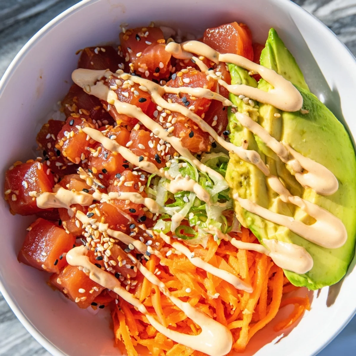 Spoon into this colorful Spicy Tuna Poke Bowl with Sriracha Mayo, topped with edamame and a spicy drizzle.
