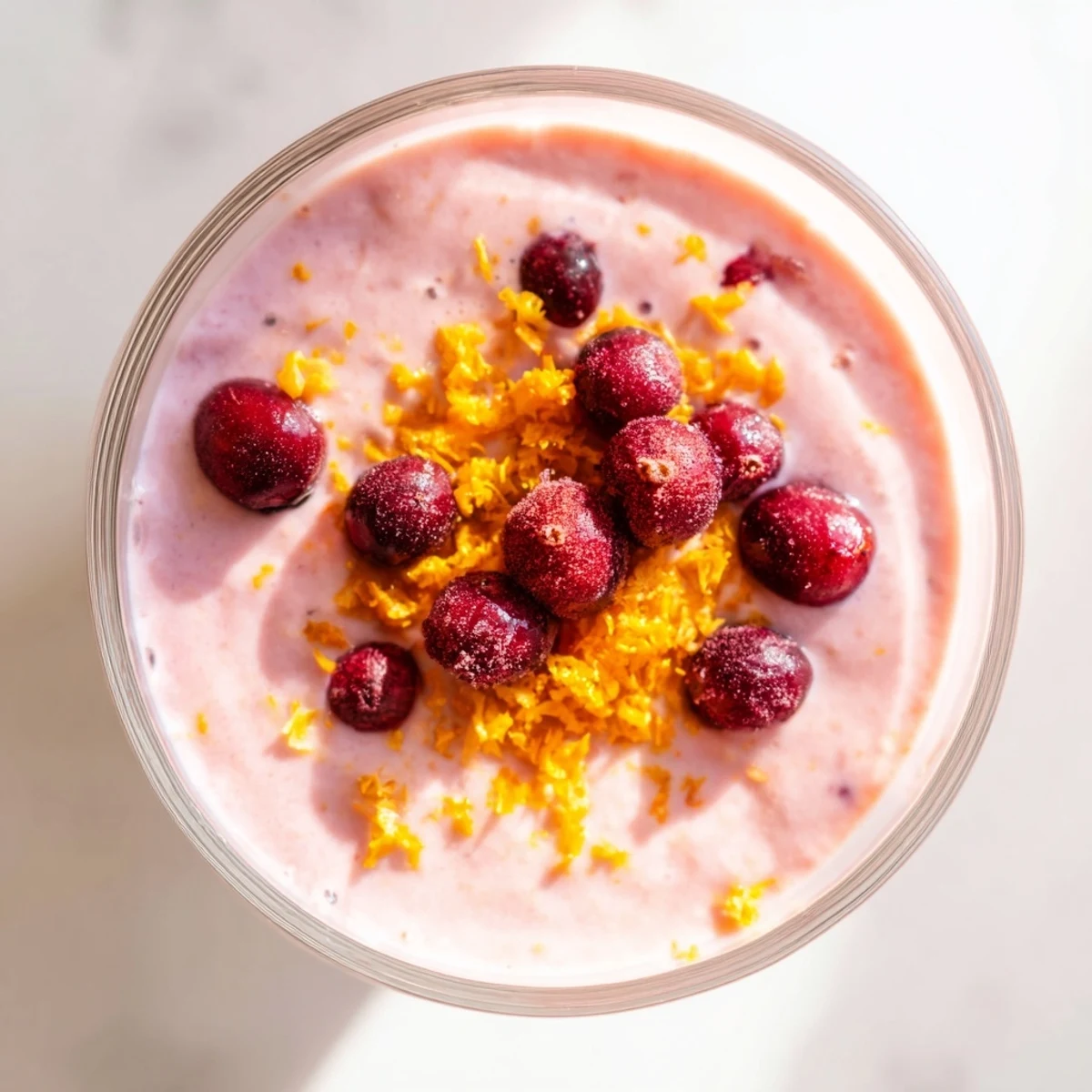 Creamy Cranberry Orange Smoothie with Yogurt, garnished with fresh zest, served in a chilled glass for a refreshing breakfast.