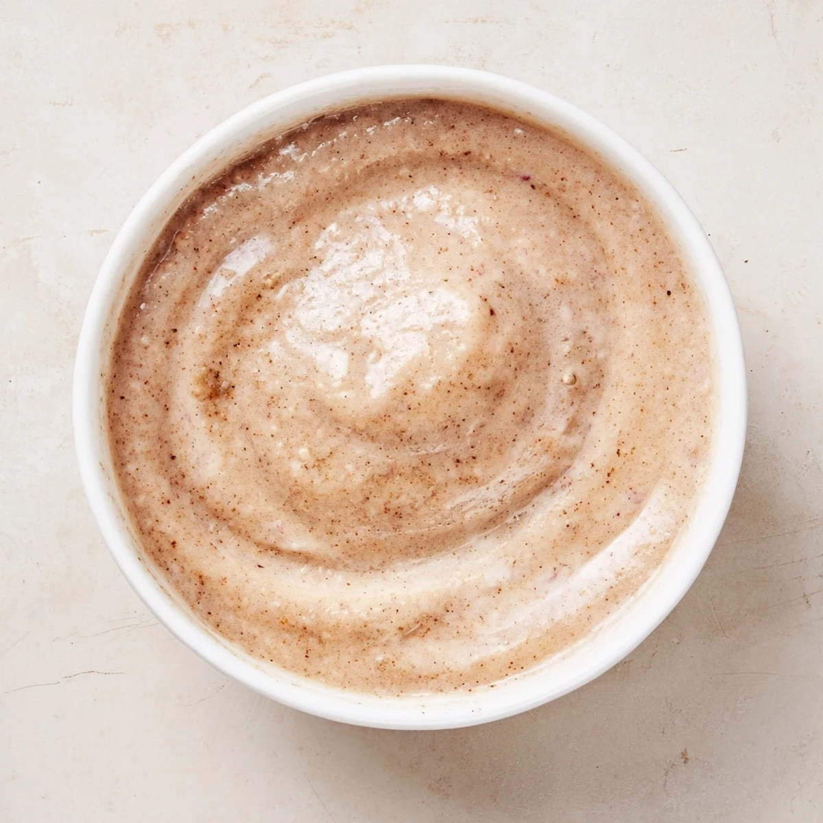 A vibrant, creamy Winter Smoothie Blend poured high, garnished with cinnamon sticks and fresh pear slices.