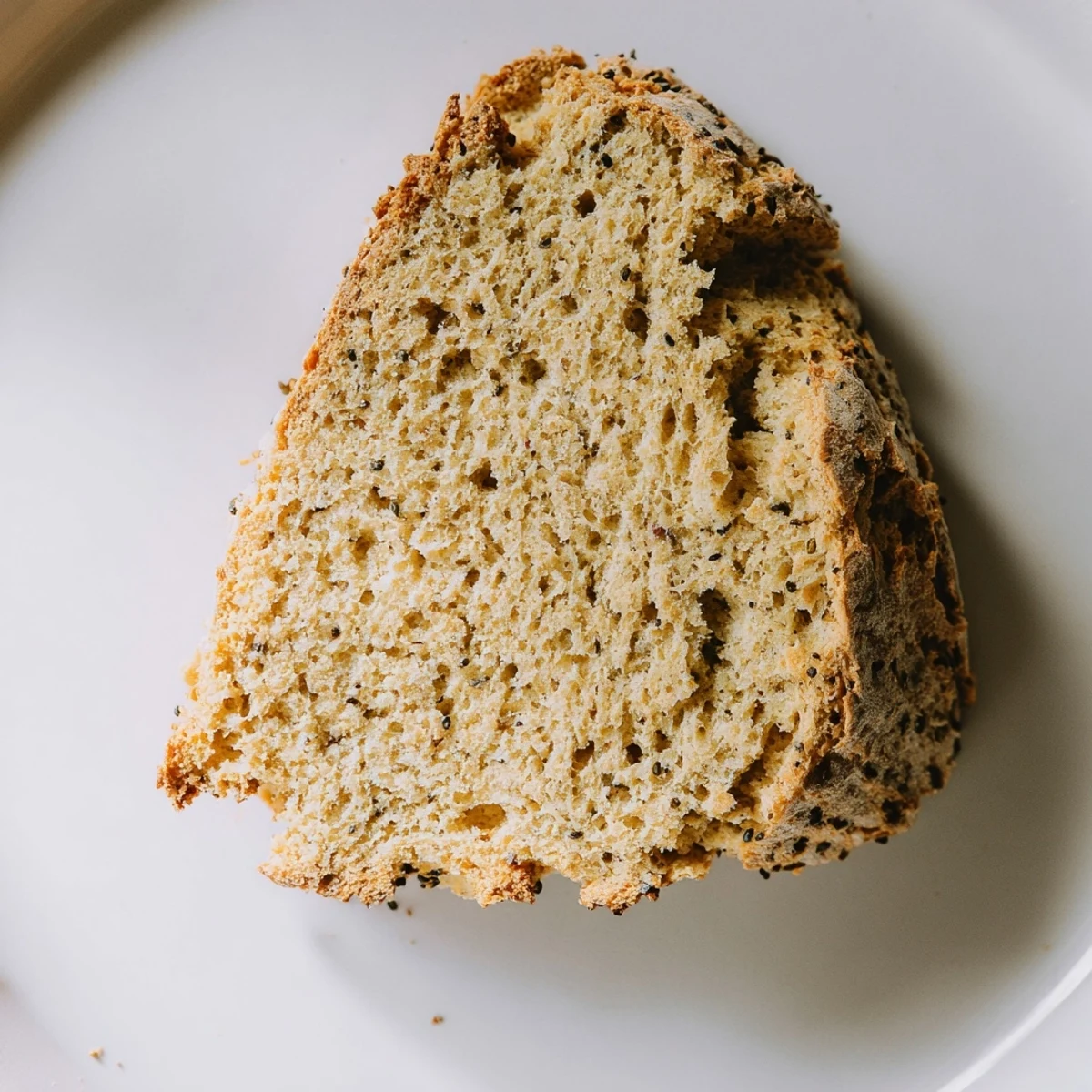 A close-up shows the crumb of Irish Soda Bread with Caraway Seeds, highlighting the tender interior and caraway flecks.