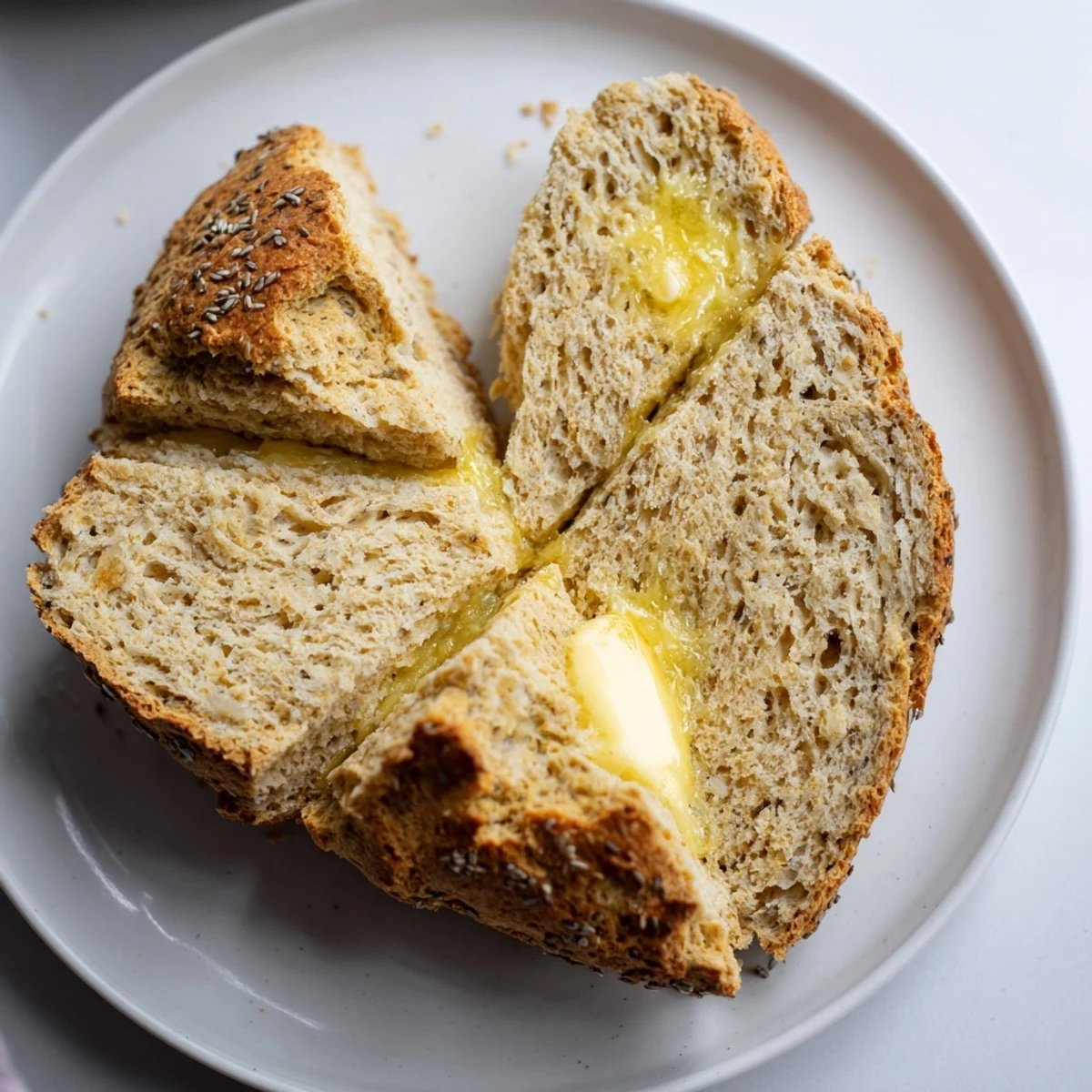 Freshly baked Irish Soda Bread with Caraway on a wooden board, showcasing its golden crust and tender crumb.