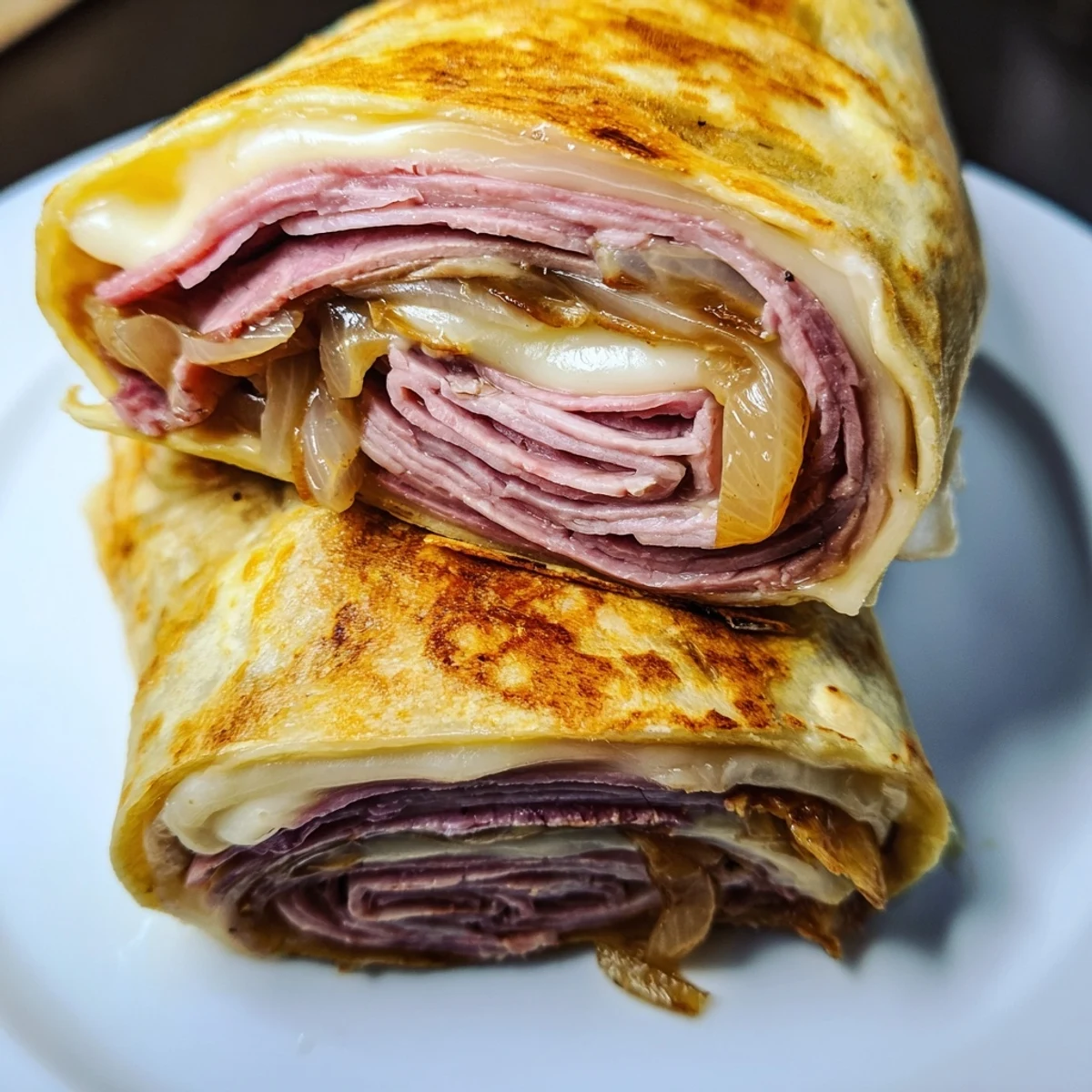 Easy French Dip Tortilla Roll Ups arranged on a wooden board, featuring baked flour tortillas with savory fillings and steam rising from a side of hot dipping sauce.