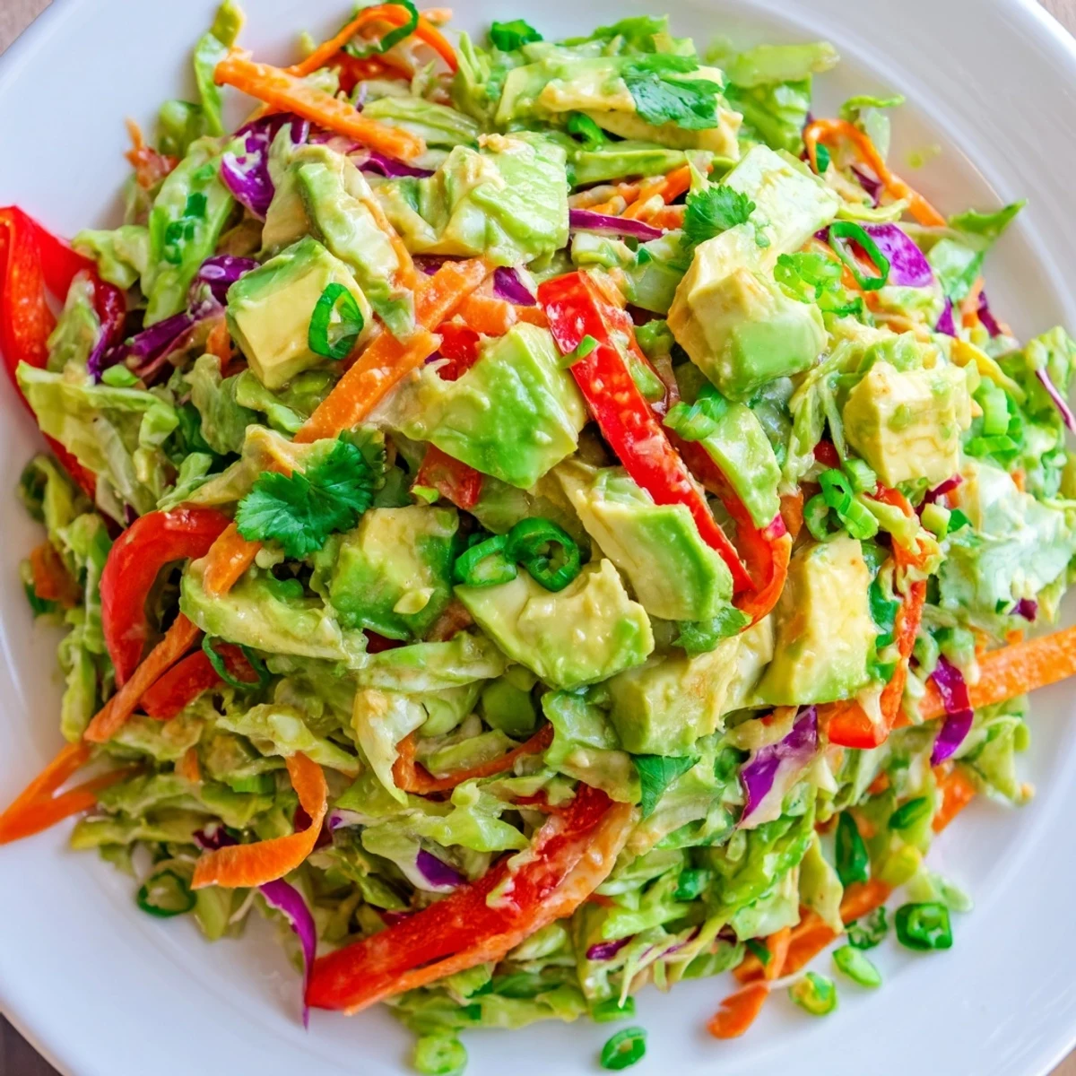Close-up of avocado cabbage salad with diced avocado and shredded cabbage, served as a healthy vegan side.