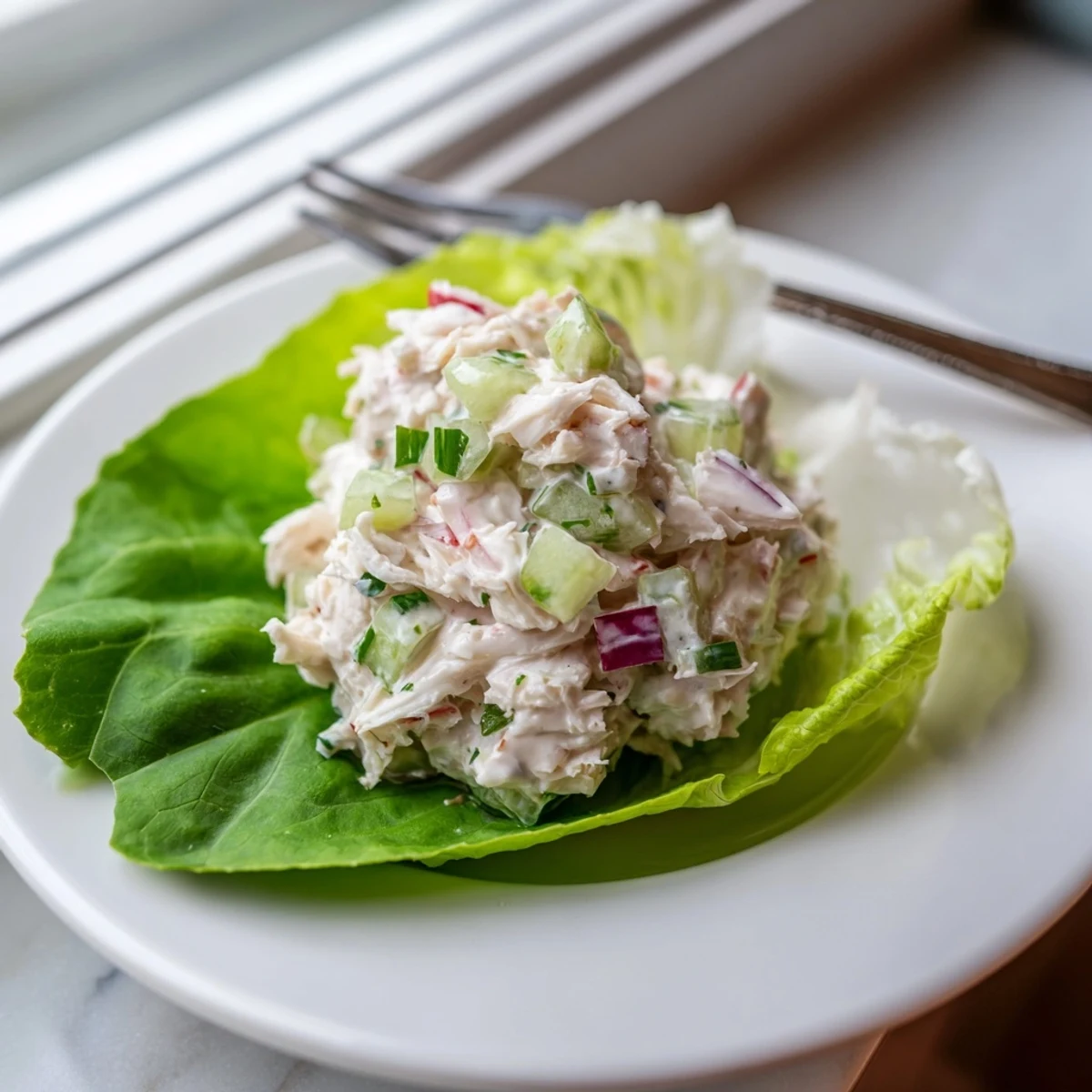 Bright lemon wedge garnish highlights this chilled crab salad, perfect for a light lunch.