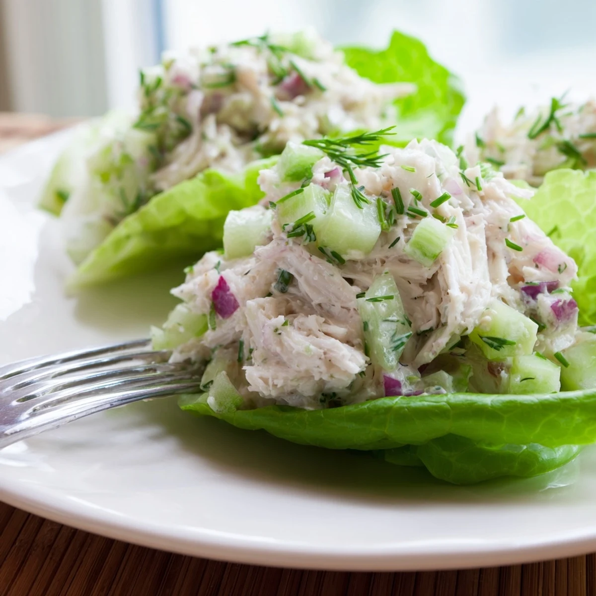 Crab salad features diced celery, cucumber, red onion, and herbs in a tangy dressing.