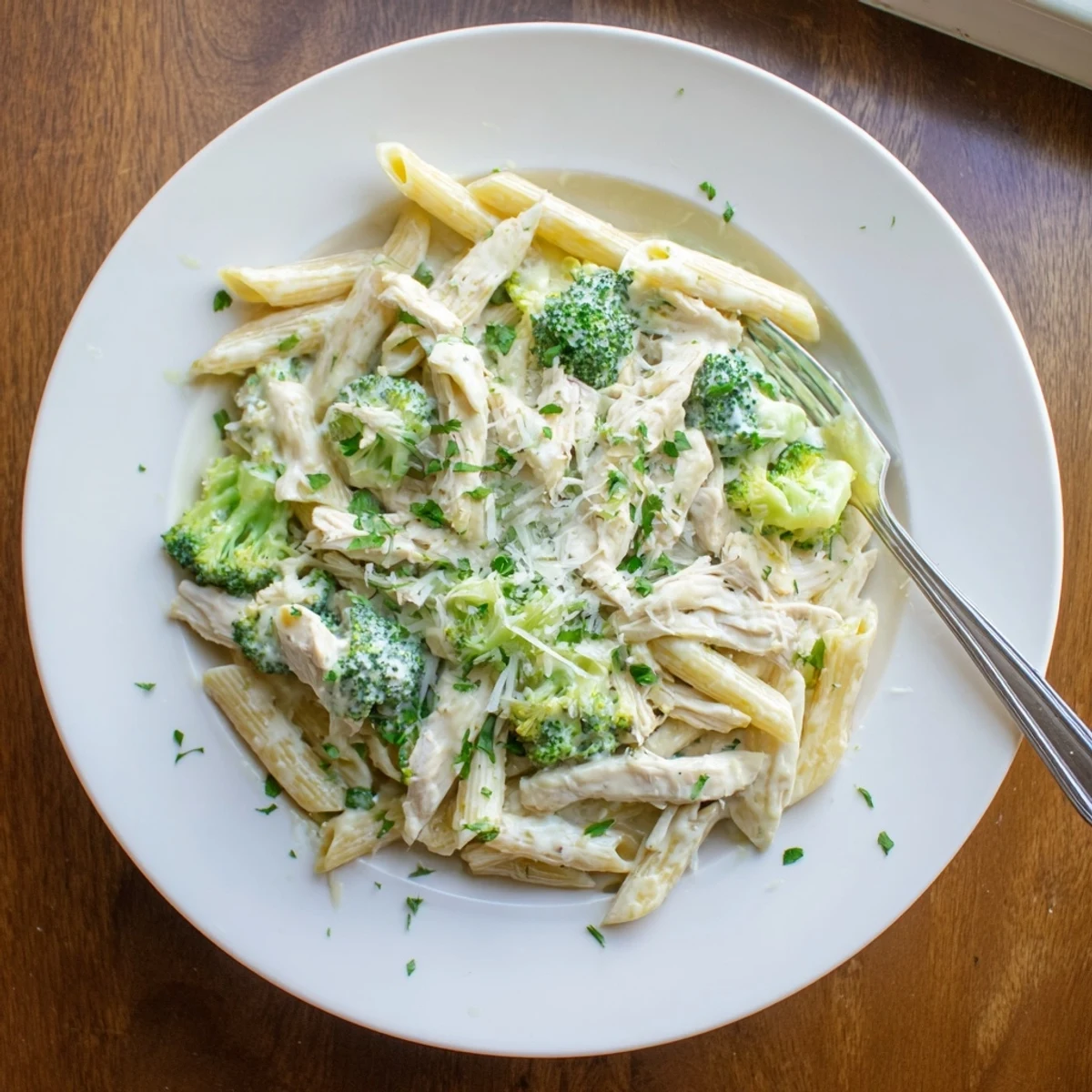 Comforting rotisserie chicken broccoli pasta served hot with shredded chicken and steamed broccoli in creamy sauce