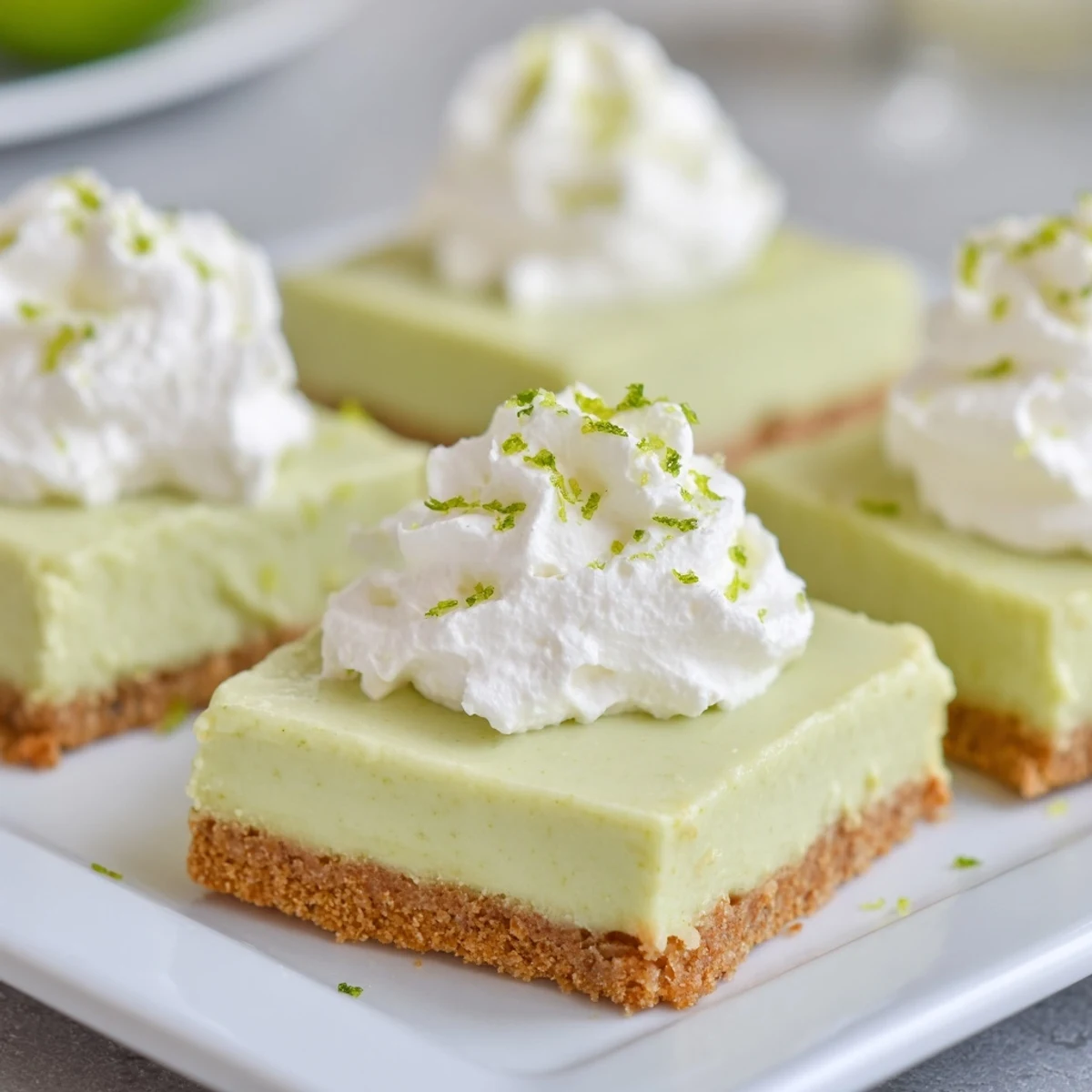 Creamy Key Lime Pie Bars with graham cracker crust dusted with green lime zest