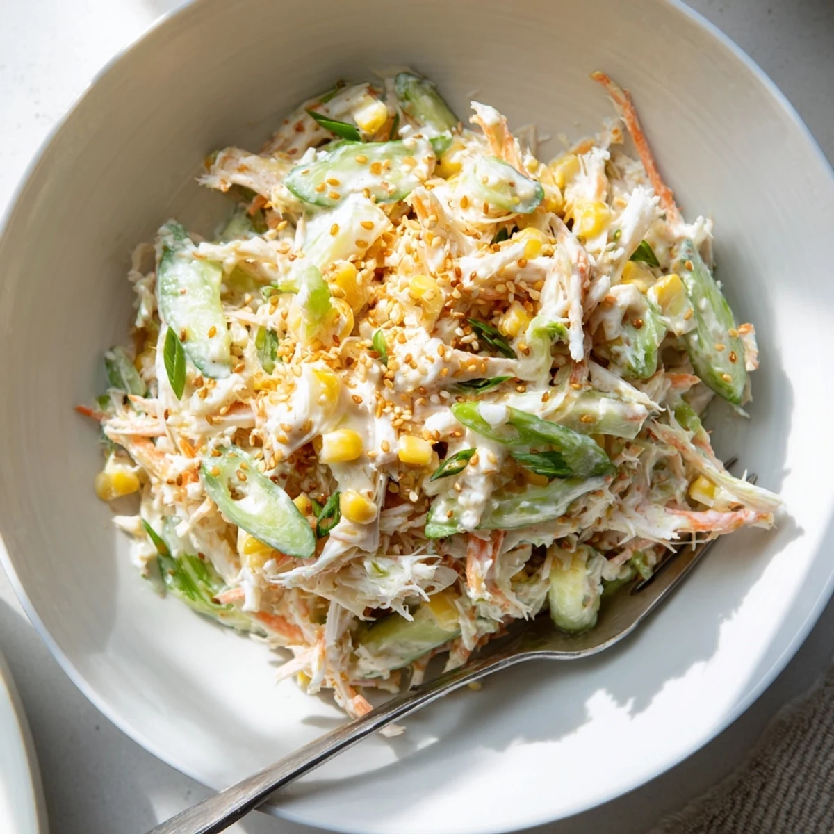 Refreshing Japanese Kani salad featuring shredded imitation crab in spicy sesame mayonnaise sauce