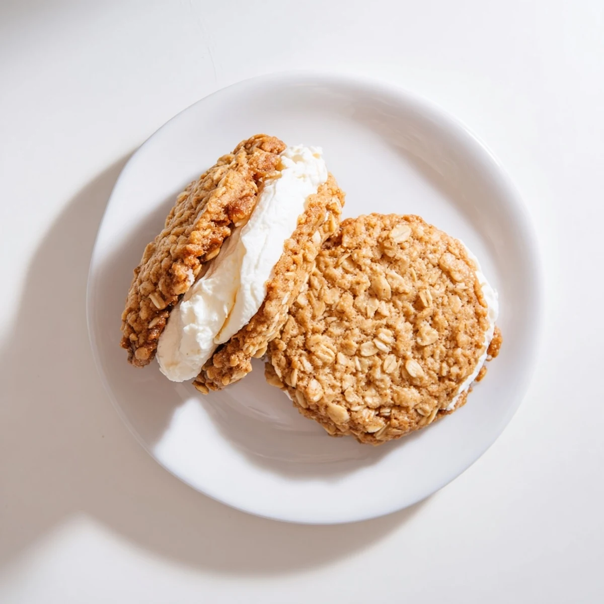 Stack of nostalgic oatmeal cream pies featuring textured oat cookies and sweet vanilla buttercream filling