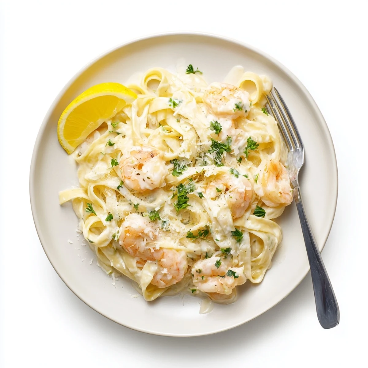 Creamy shrimp fettuccine pasta with homemade Alfredo sauce garnished with fresh parsley