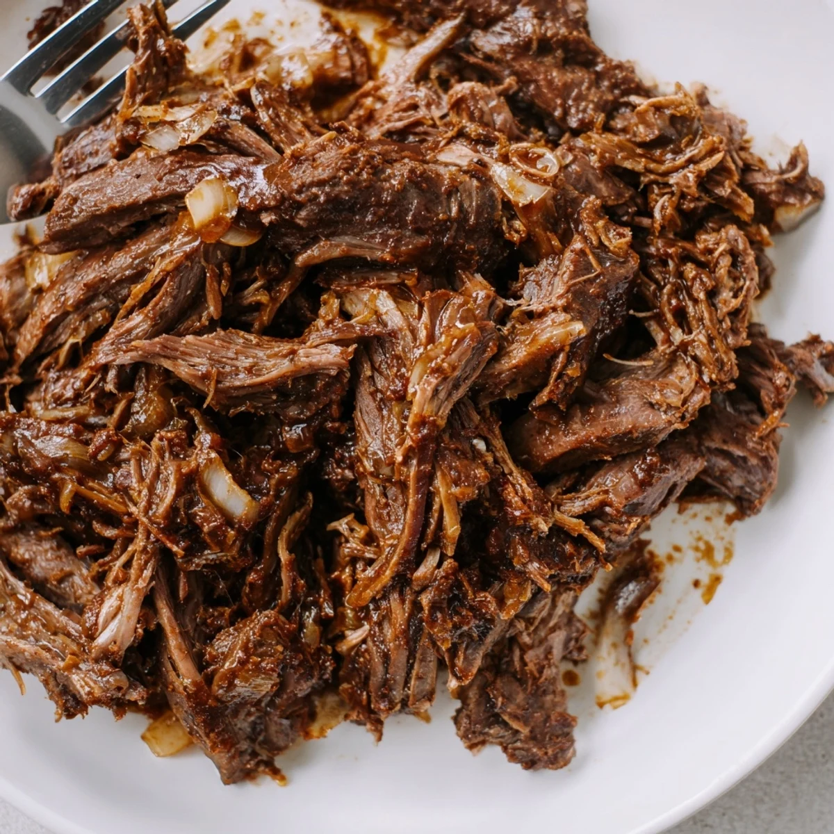 Tender Crock Pot shredded beef piled high with juices, perfect for tacos or sandwiches