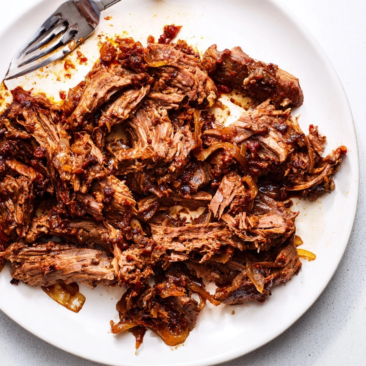 Fork-tender Crock Pot shredded beef ready to serve over rice or in warm tortillas
