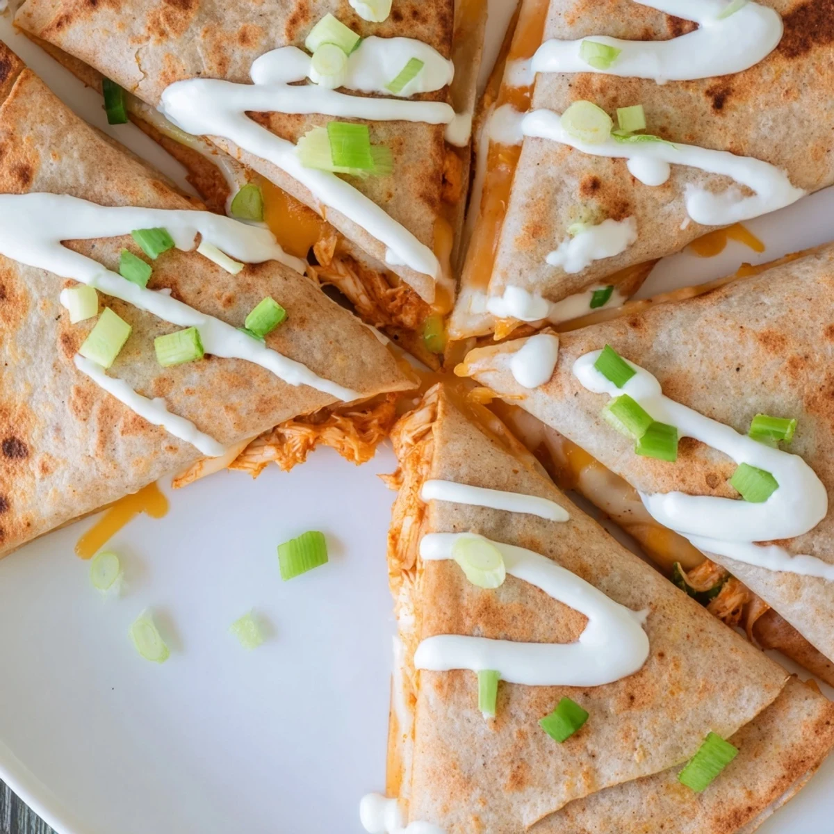 Crispy flour tortilla quesadillas filled with Buffalo chicken and finished with ranch