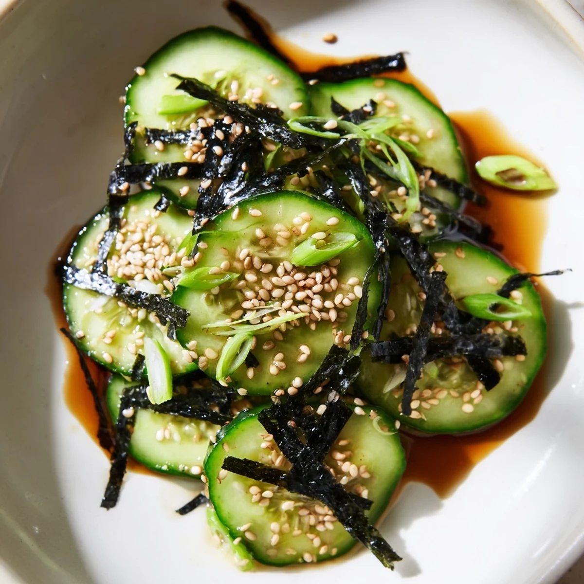 Thinly sliced English cucumbers with nori strips and sesame seeds in this Japanese-inspired sushi cucumber salad