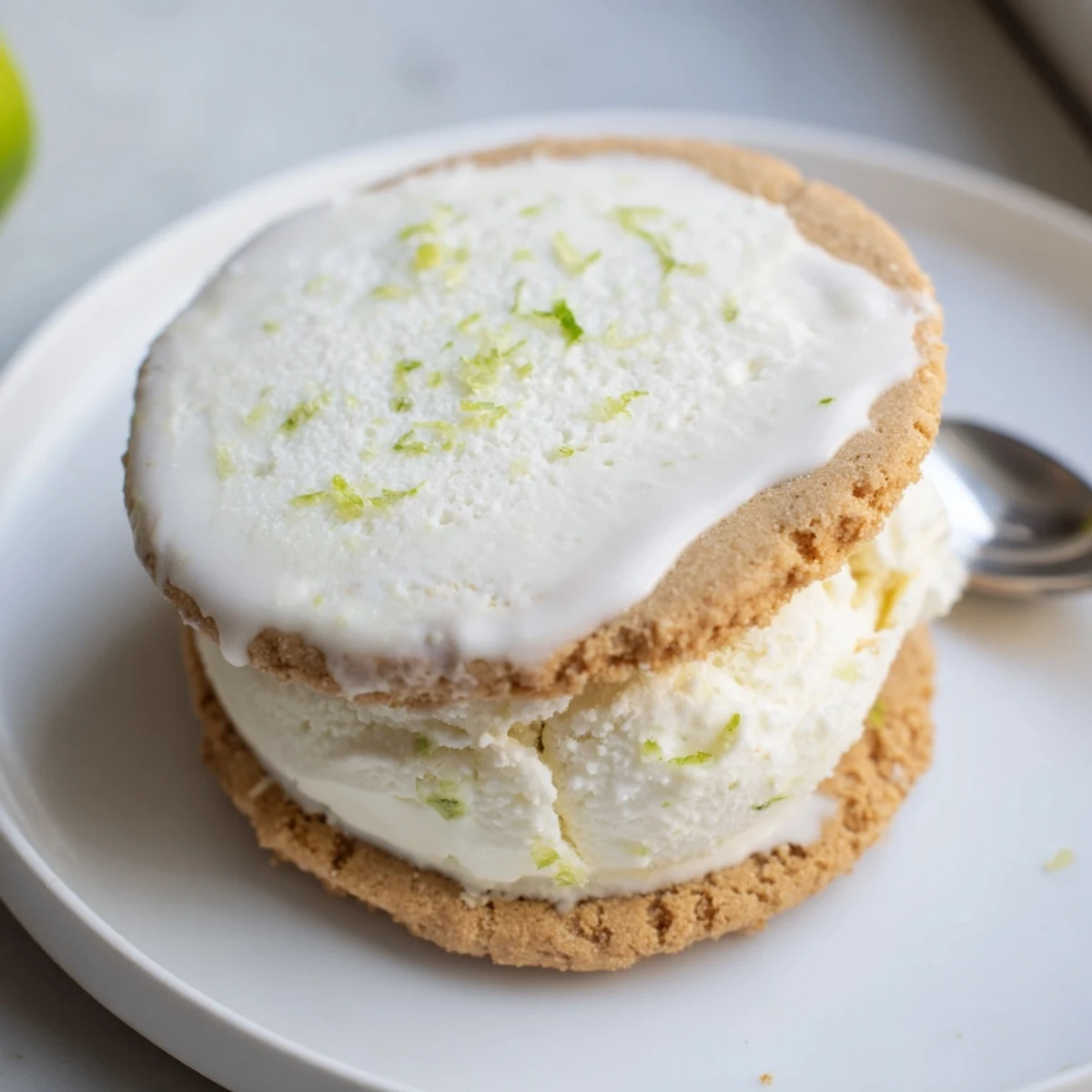 Two Key Lime Pie Ice Cream Sandwiches on a plate, tangy, refreshing summer dessert