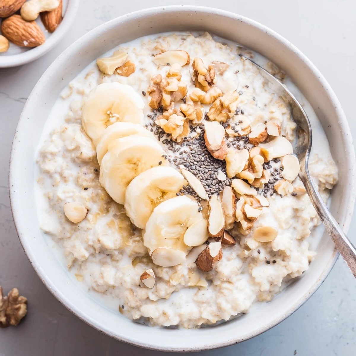 Protein Oatmeal topped with sliced banana, walnuts, and juicy fresh berries
