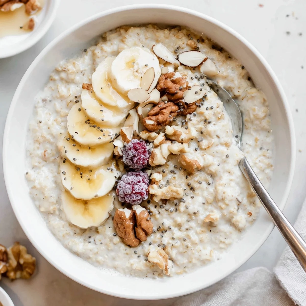 Hearty morning Protein Oatmeal stirred smooth, crowned with crunchy almonds