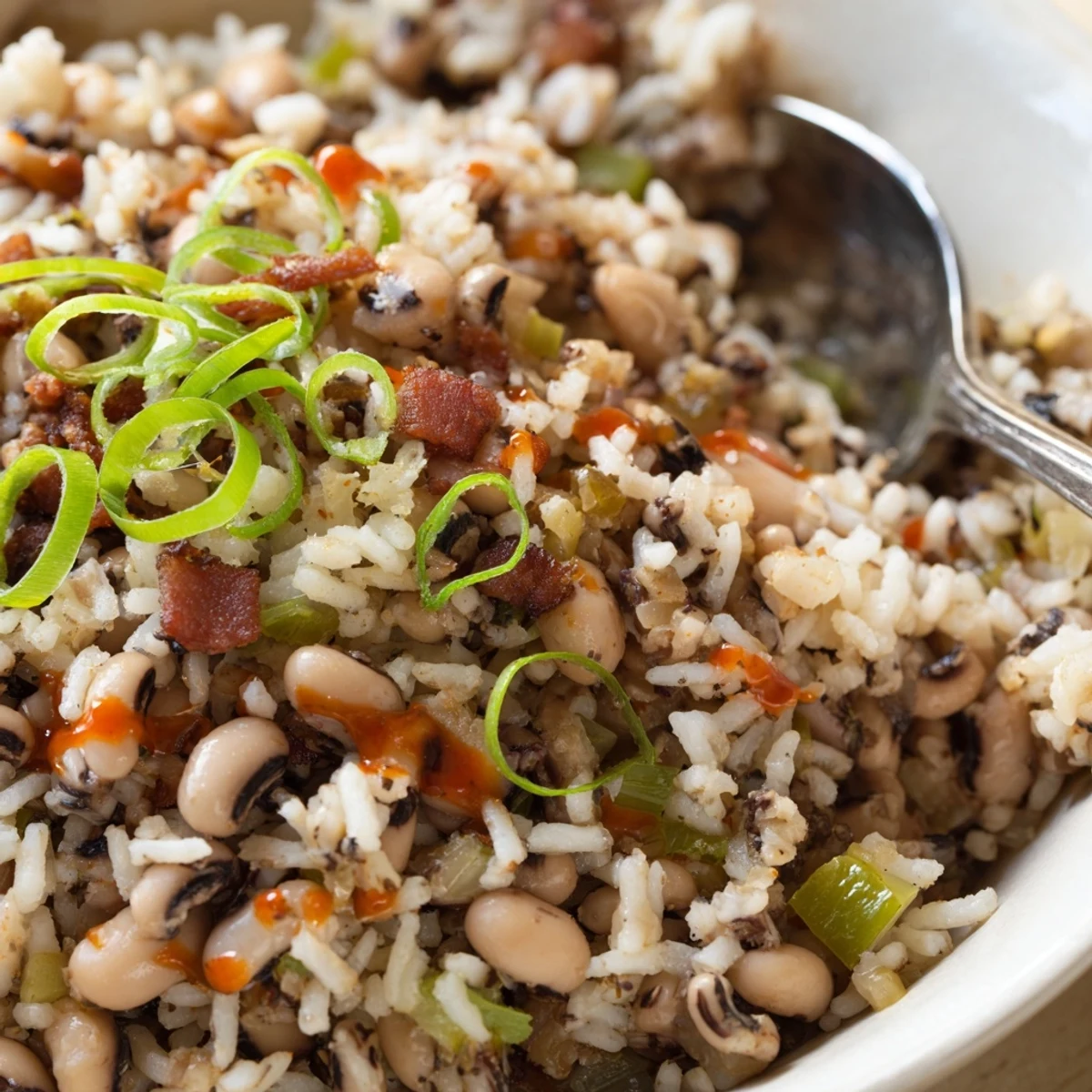 Slow-simmered Hearty Smoky Southern Hoppin John beside warm cornbread and hot sauce