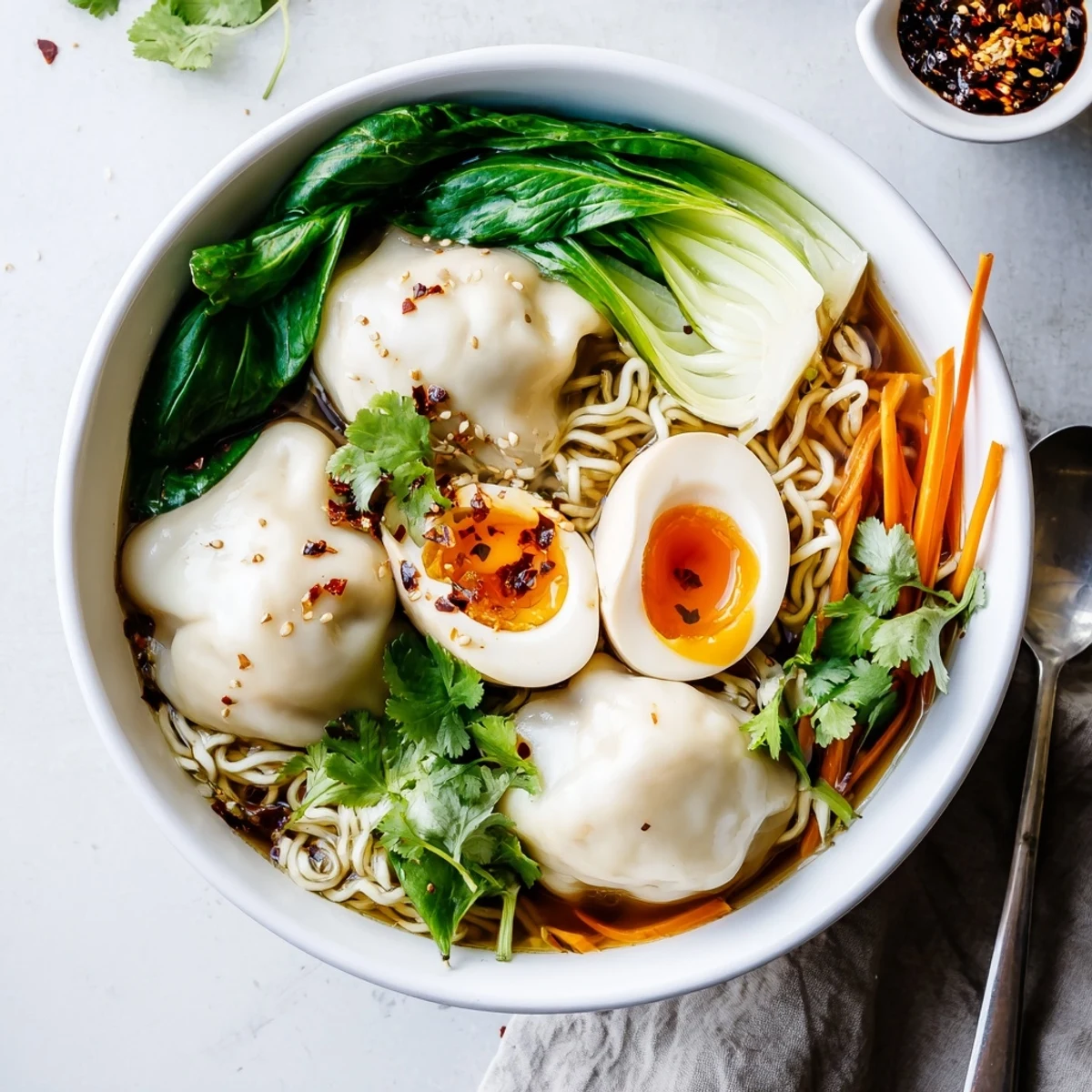 Dumpling Ramen Bowl With Soft Boiled Eggs And Fresh Greens in steaming savory broth