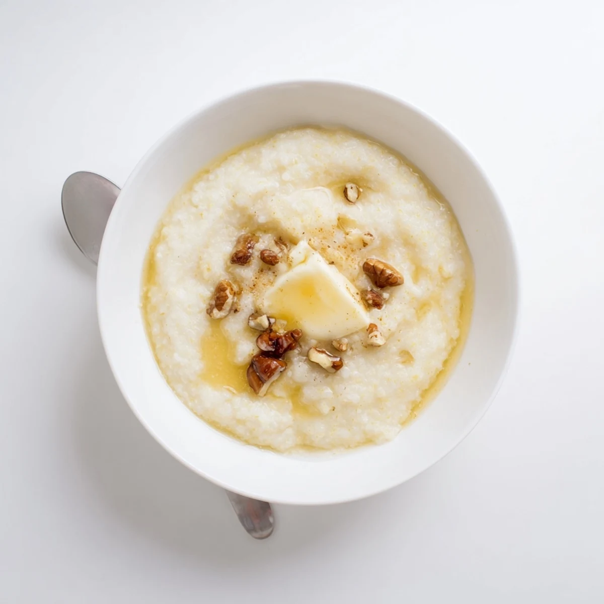 Comforting maize porridge served with dried fruits and warm milk on a wooden table