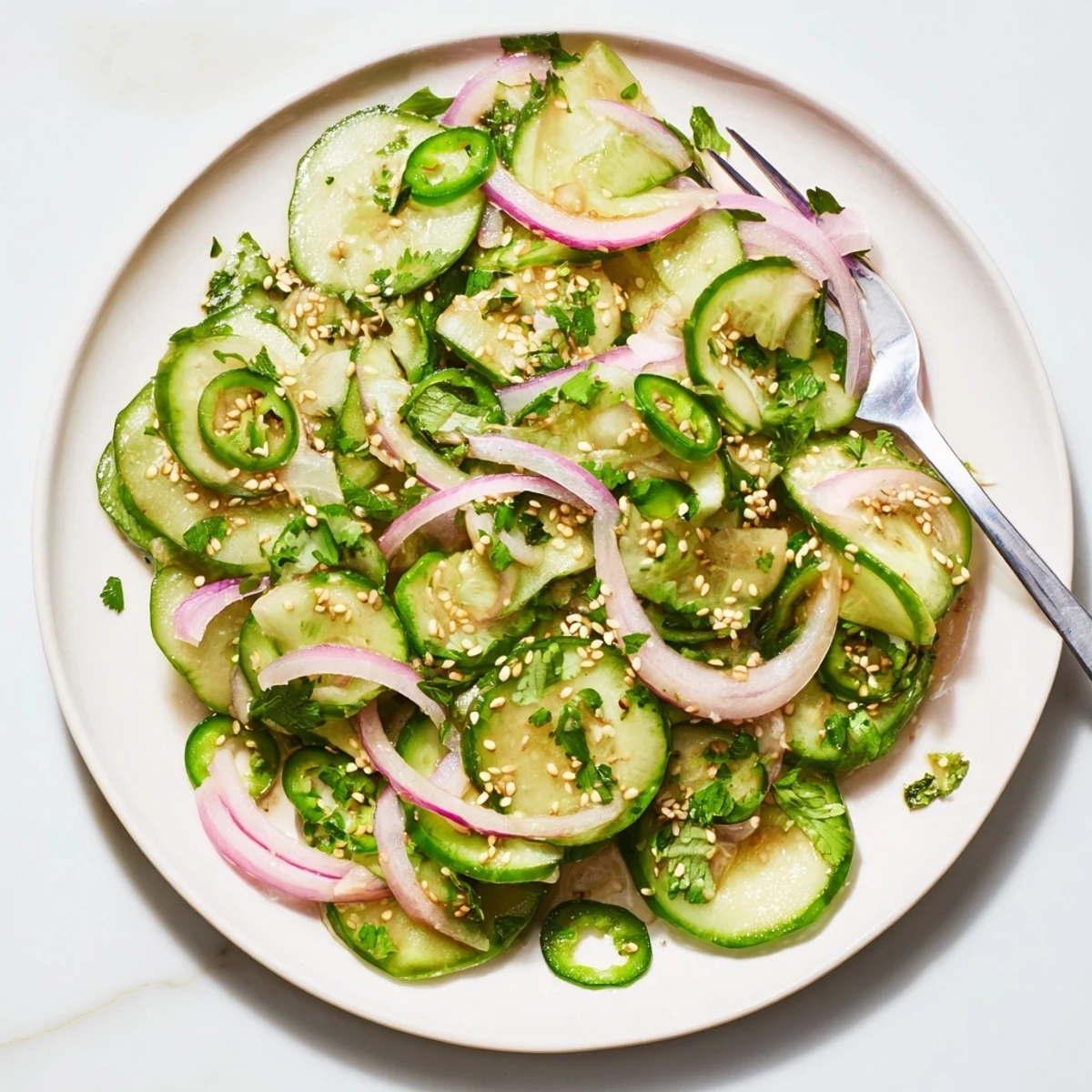 Fresh honey lime cucumber salad with crisp sliced cucumbers in a tangy citrus dressing bowl