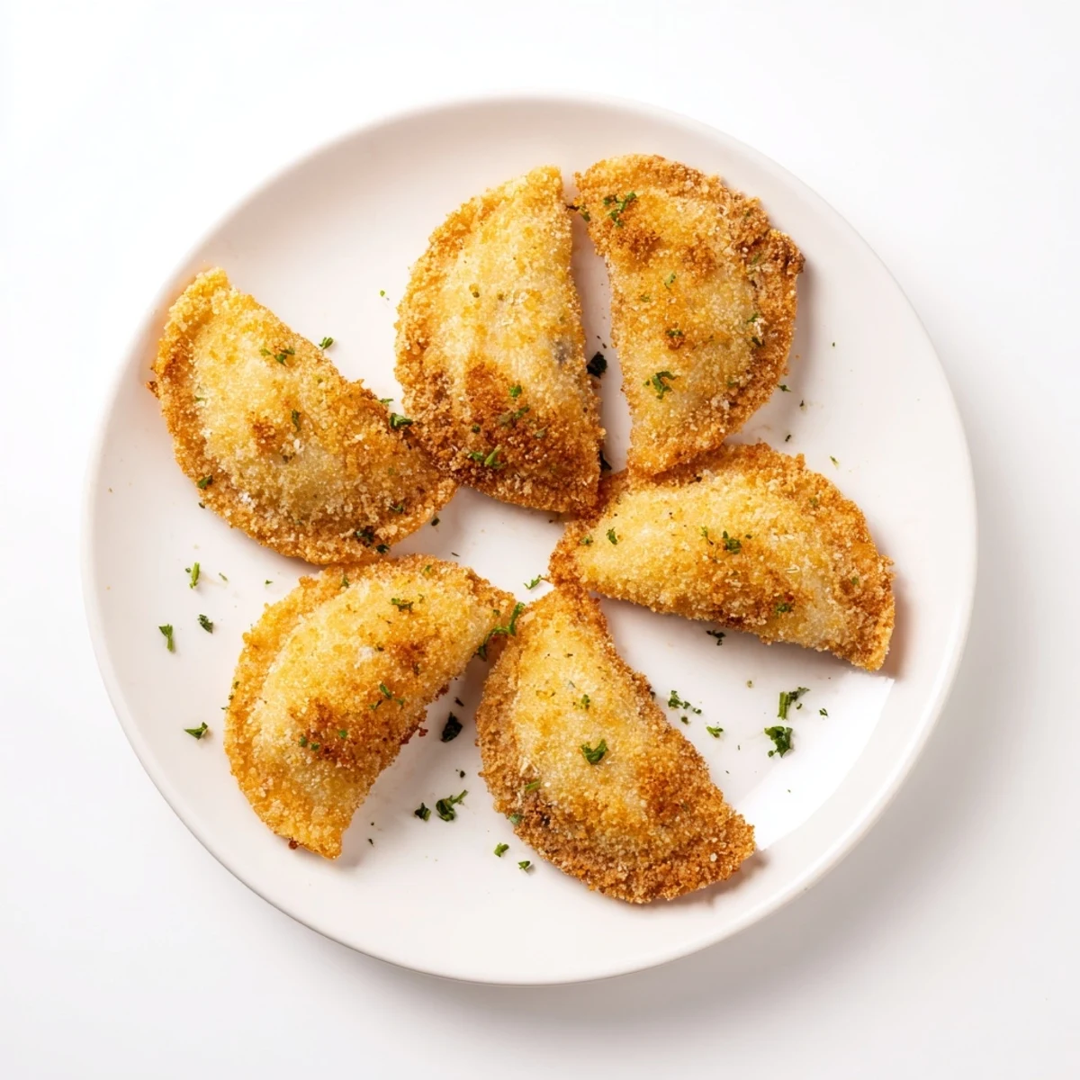 Golden brown Portuguese shrimp rissois with crispy crust and creamy filling on serving platter