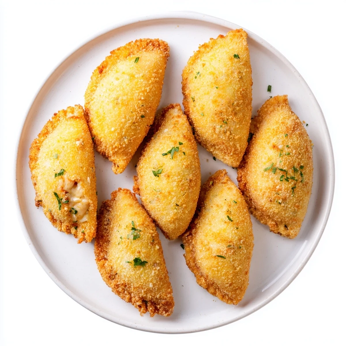 Crispy fried Portuguese shrimp rissois appetizers arranged on white plate with lemon wedges