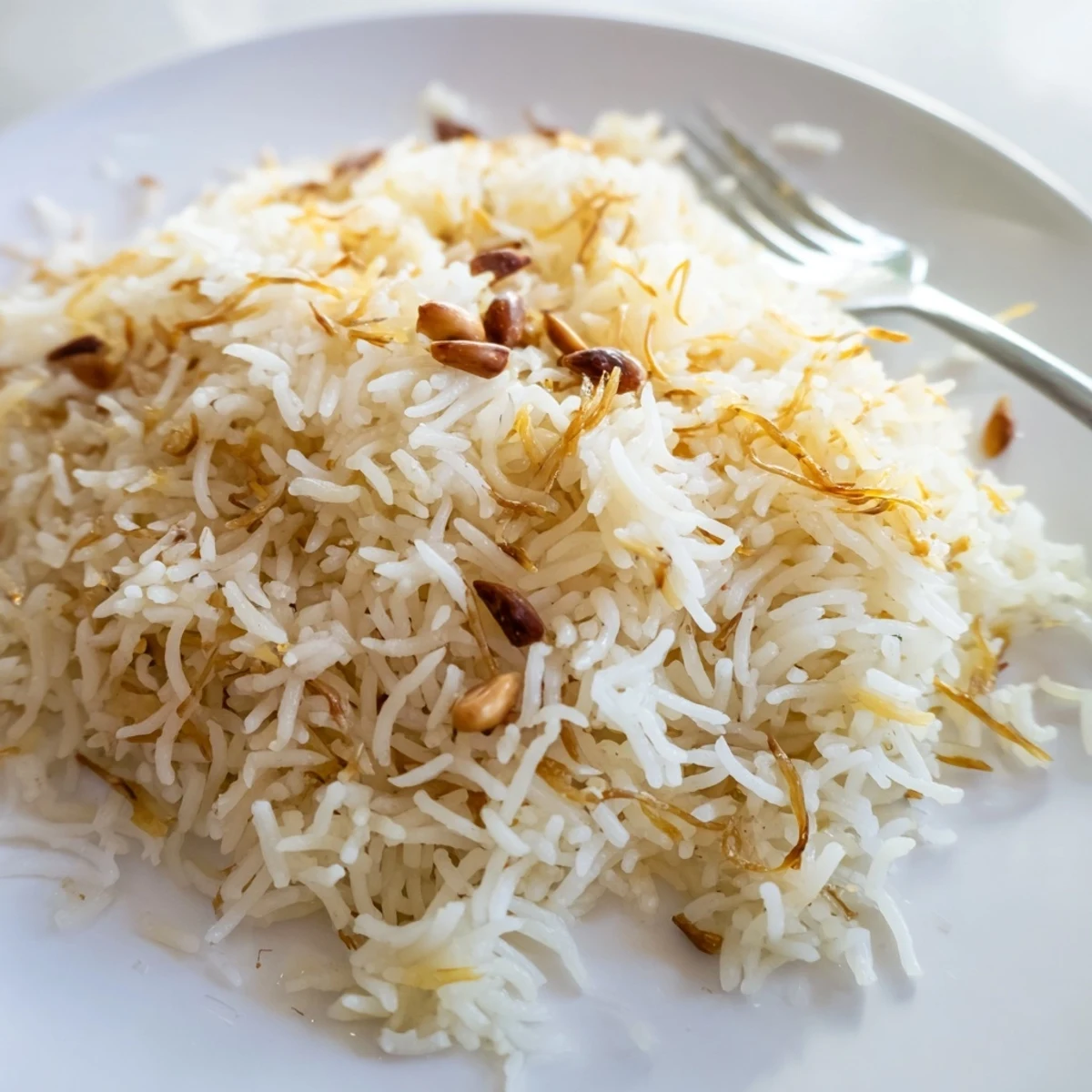 A fork fluffs tender Lebanese rice studded with crispy browned vermicelli noodles