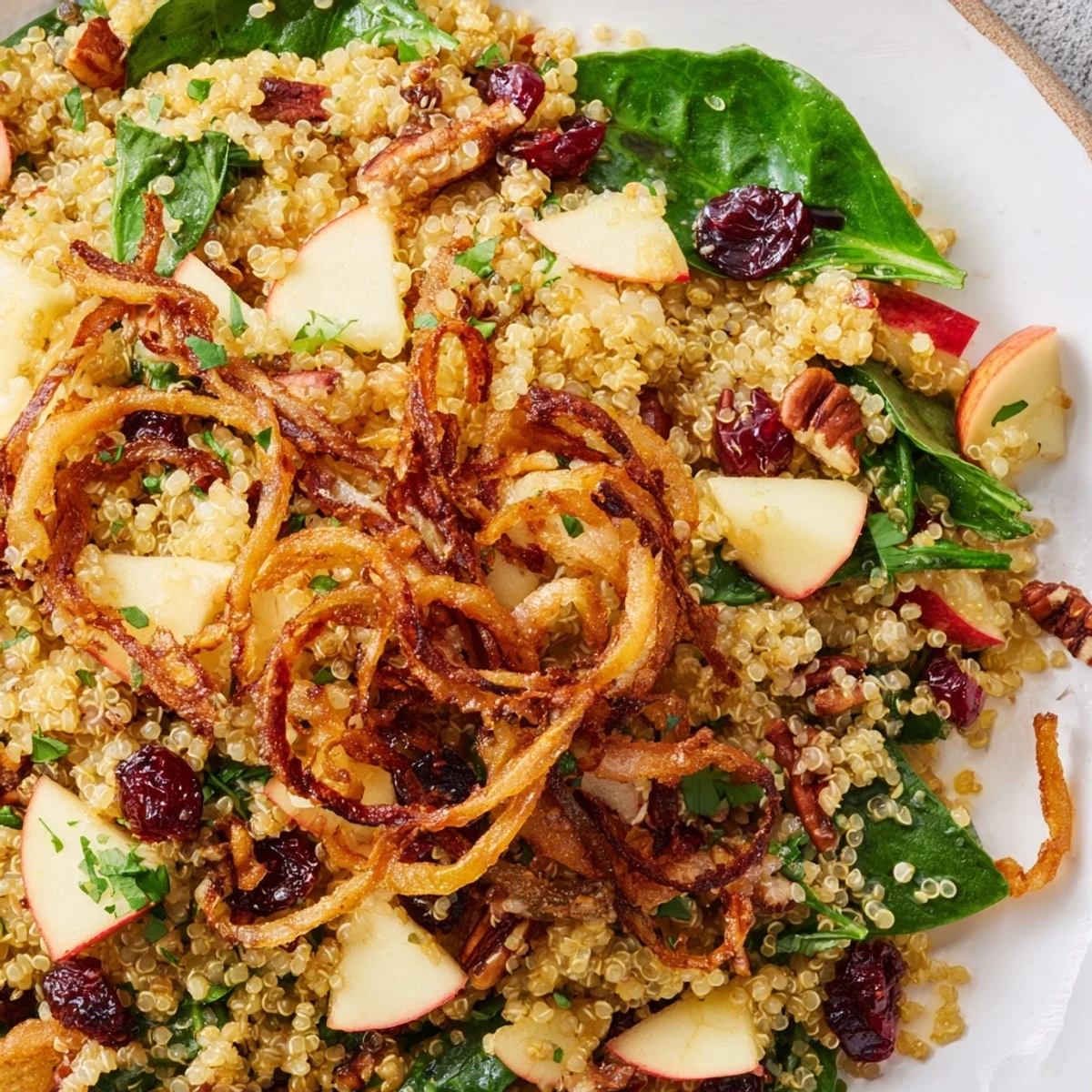 A colorful close-up of Honey Mustard Quinoa Apple Salad With Crispy Shallots
