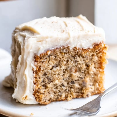Moist brown butter banana cake layered with pillowy cream cheese frosting, ready for a celebration crowd